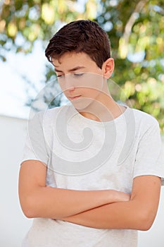 Sad teenager boy looking down outdoor