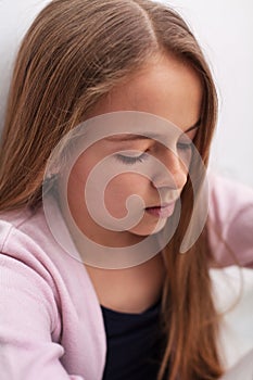 Sad teenager girl with downcast eyes - closeup portrait photo