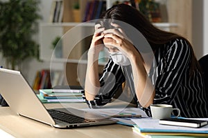 Sad teleworker with problems due at home photo