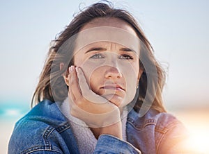 Sad, thinking and depression with woman at beach feeling stress, exhausted and problems. Mental health, crisis and