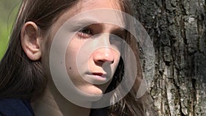 Sad Thoughtful Girl by Tree, Unhappy Kid, Depressed Teenager Child Not Playing, Depression of Adolescents in Coronavirus Pandemic