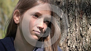 Sad Thoughtful Girl by Tree, Unhappy Kid, Depressed Teenager Child Not Playing, Depression of Adolescents in Coronavirus Pandemic