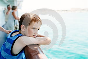 Sad thoughtful little boy looking at the sea