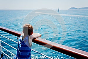 Sad thoughtful little boy looking at the sea