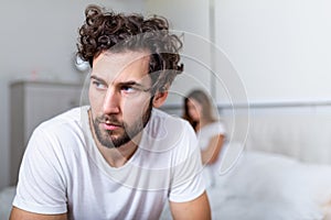 Sad thoughtful man after arguing with girlfriend.Relationship difficulties, conflict and family concept,unhappy couple having