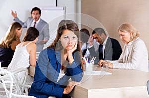 Sad and tired business woman on meeting