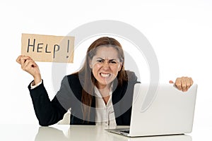 Sad and tired businesswoman holding a help sign feeling helpless and frustrated