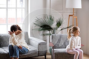 Sad tired mother and sulky daughter not talking after conflict