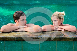 Sad and unhappy couple in swimming pool