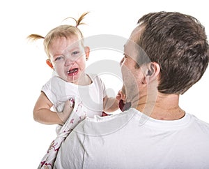 Sad unhappy crying cute little young toddler girl wiping tears, isolated.