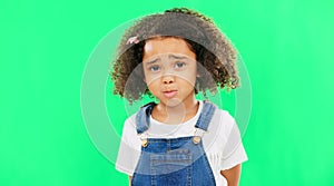 Sad, unhappy and face of a child on a green screen isolated on a studio background. Trouble, crying and portrait of a