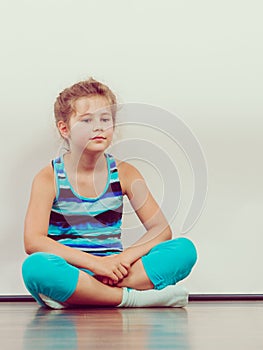 Sad unhappy little girl kid in studio.