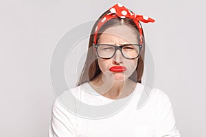 Sad unhappy portrait of beautiful emotional young woman in white
