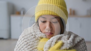 Sad upset Asian frozen chinese japanese korean woman at cold apartment heating problem freezing at home sick girl wear