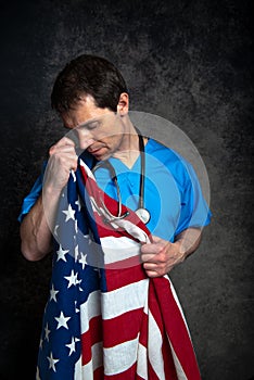 Sad / upset doctor nursing the American flag.