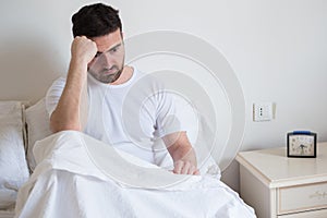 Sad and upset man waking up in the morning