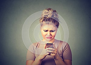 Sad upset woman using mobile phone