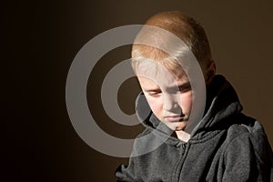 Sad upset worried unhappy little child (boy)