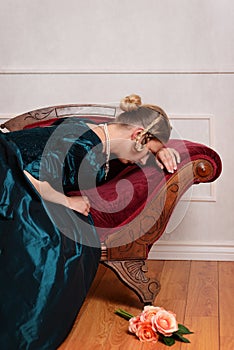 Sad victorian woman on fainting couch photo