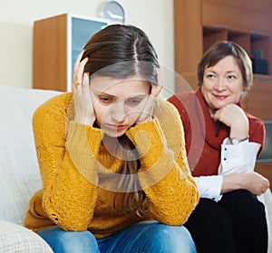 Sad woman against mature mother after conflict