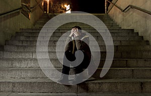 Sad woman alone on street subway staircase suffering depression looking looking sick and helpless