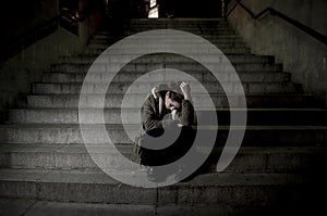 Sad woman alone on street subway staircase suffering depression looking looking sick and helpless