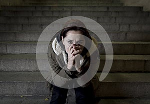 Sad woman alone on street subway staircase suffering depression looking looking sick and helpless