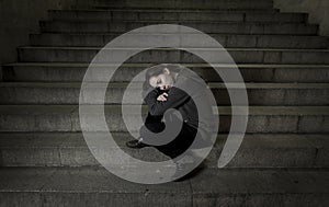 Sad woman alone on street subway staircase suffering depression looking looking sick and helpless