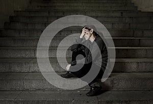 Sad woman alone on street subway staircase suffering depression looking looking sick and helpless