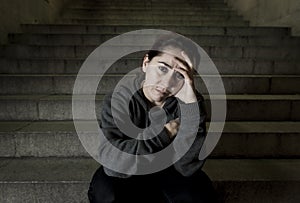 Sad woman alone on street subway staircase suffering depression looking looking sick and helpless