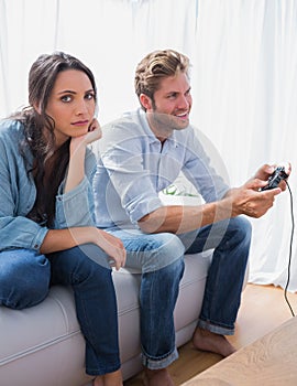 Sad woman annoyed that her partner is playing video games