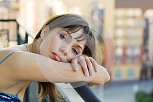 Sad woman on a balcony