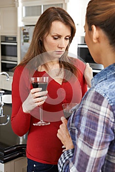 Sad Woman Being Consoled At Home By Female Friend photo