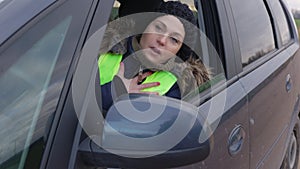 Sad woman in car struggles with shortness of breath