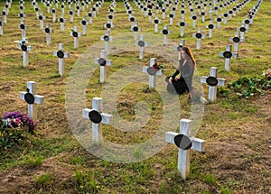 Sad woman in the cemetery .