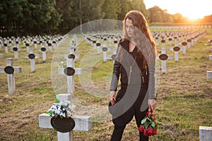 Sad woman in the cemetery .