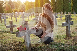 Sad woman in the cemetery .