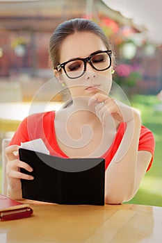 Sad Woman Checking Restaurant Bill photo