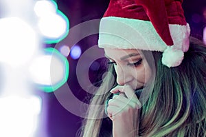 Sad woman by the christmas tree contemplating. Lonely Christmas