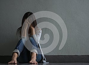 Sad woman closed her face and cry while sitting alone