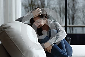 Sad woman complaining and crying at home photo