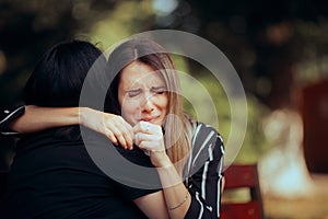 Sad Woman Crying on the Shoulder of her Best Friend