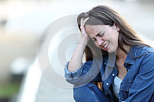 Sad woman crying in the street