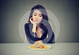 Sad woman on diet craving for fast food