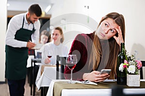 Sad woman is dining in luxury restaurante alone