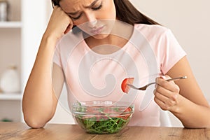 Sad Woman Eating Salad Slimming Sitting At Table At Home