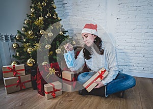 Sad woman with face mask home alone at christmas missing family and friends