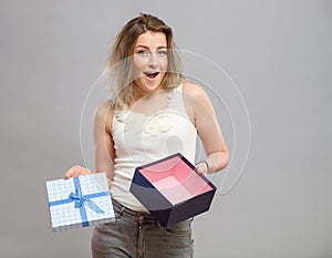 Sad woman holding gift box