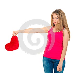 Sad woman holding red valentine heart