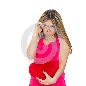 Sad woman holding red valentine heart